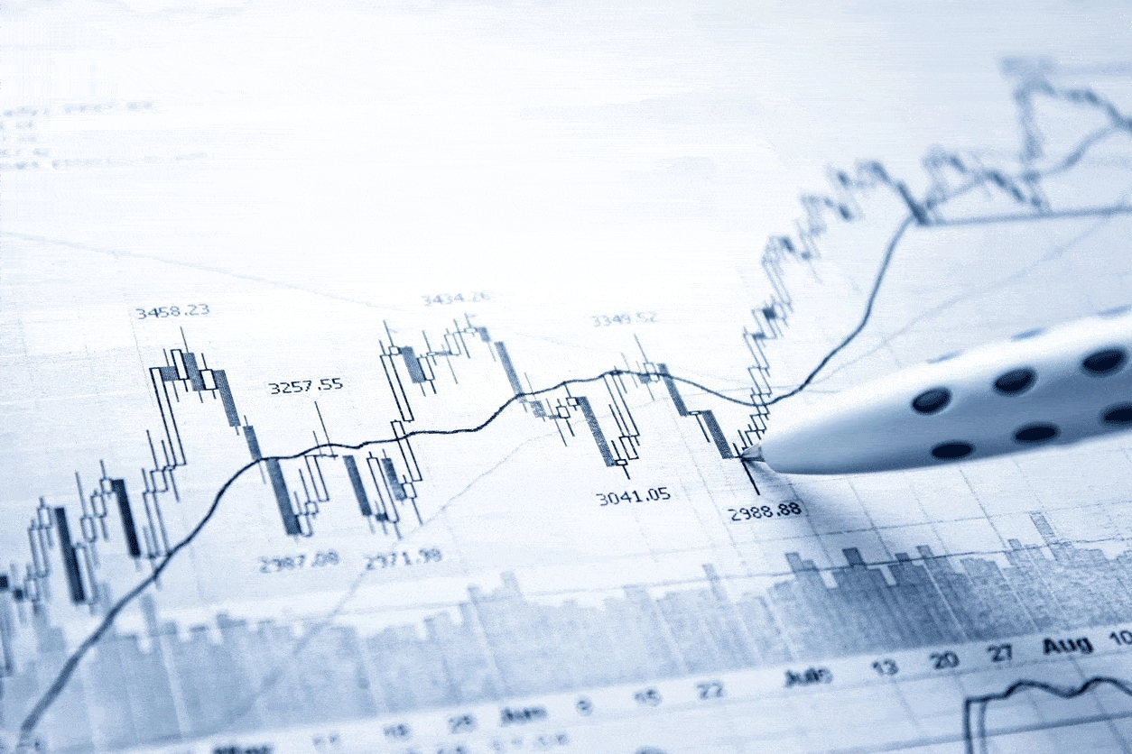 A pen is on top of a paper with graphs.